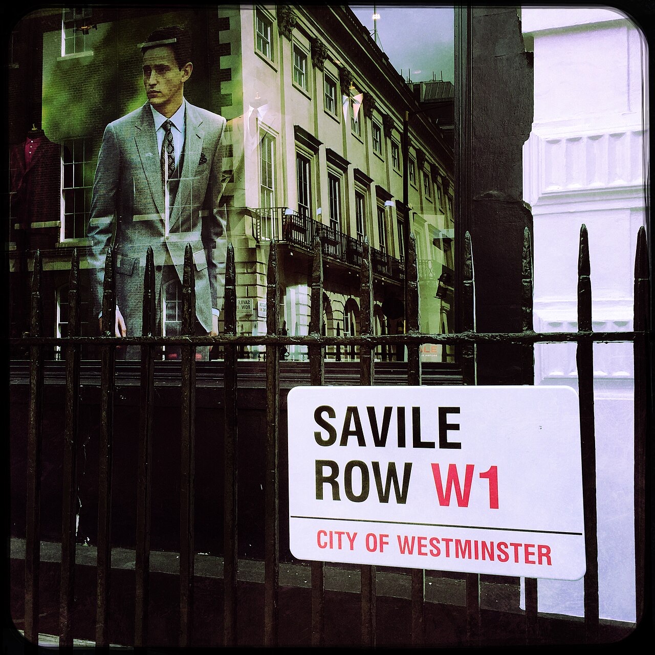 The Savile Row street sign, with a tailor's window reflected beside it