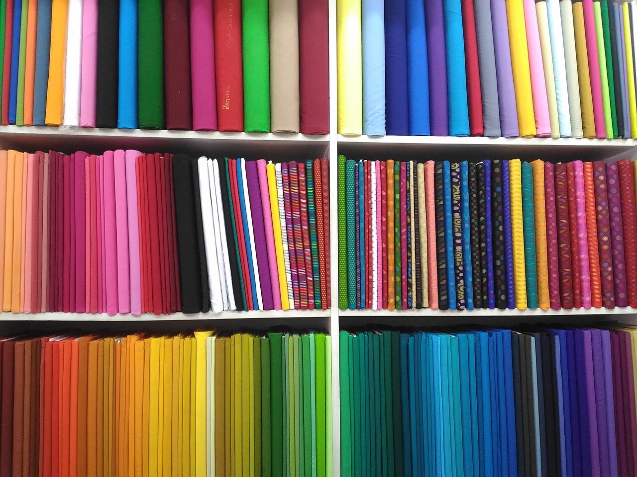 Bolts of coloured cloth in a cloth shop